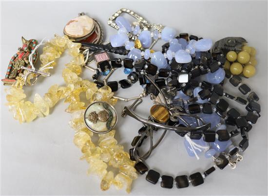 A group of assorted jewellery including tigers eye quartz necklace and other items.